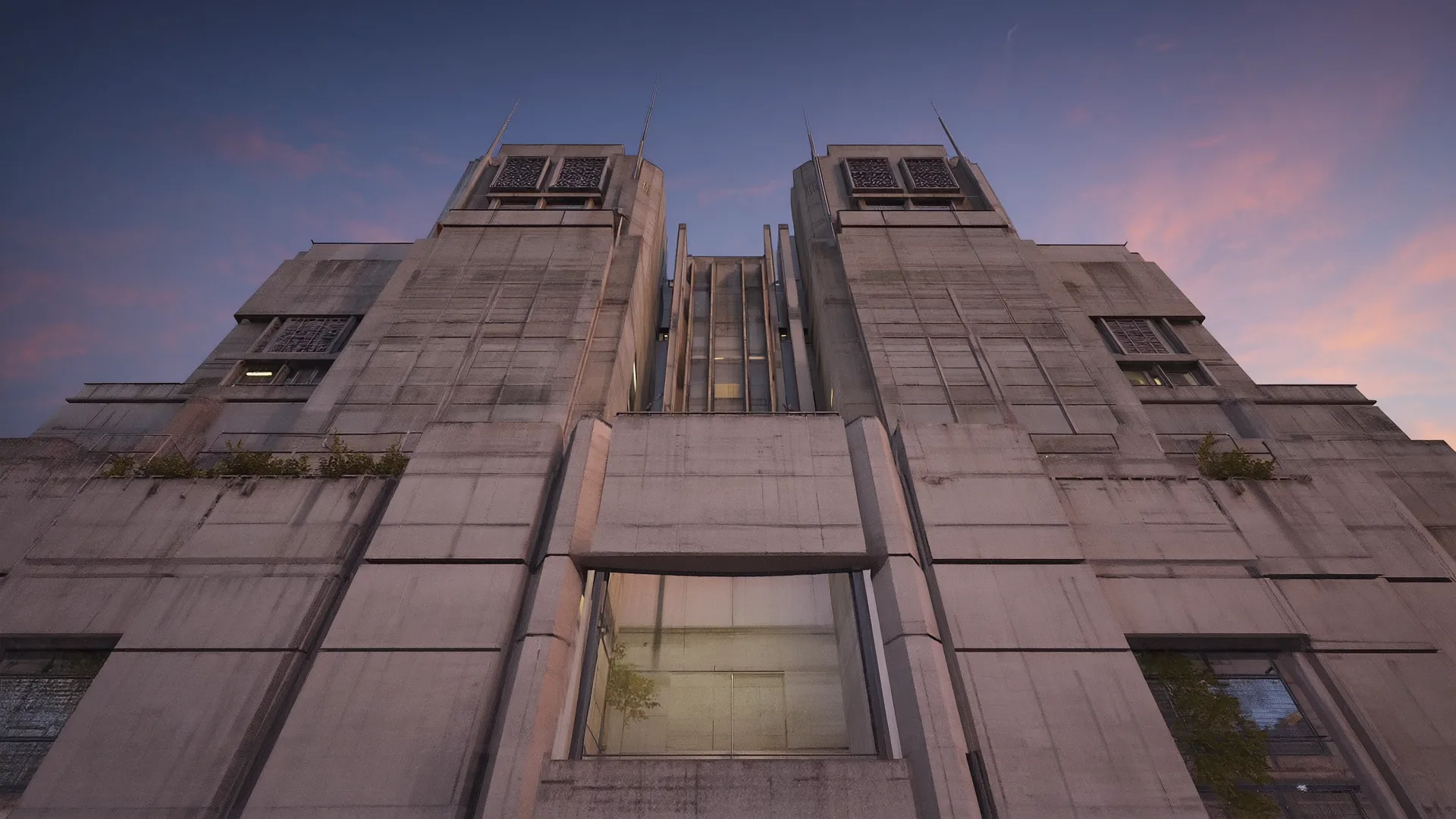 Twin concrete towers seen from below against a dusk sky